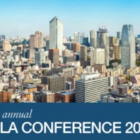Event banner for the 6th Annual ICLA Conference 2019 featuring a daylight skyline of central Tokyo with high-rise buildings under a clear blue sky. The ICLA event title is displayed on a blue footer section.