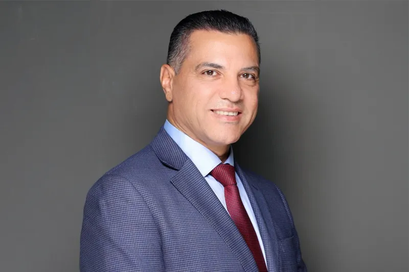 Studioportrait of Prof. Aymen Masadeh, with a dark neutral background